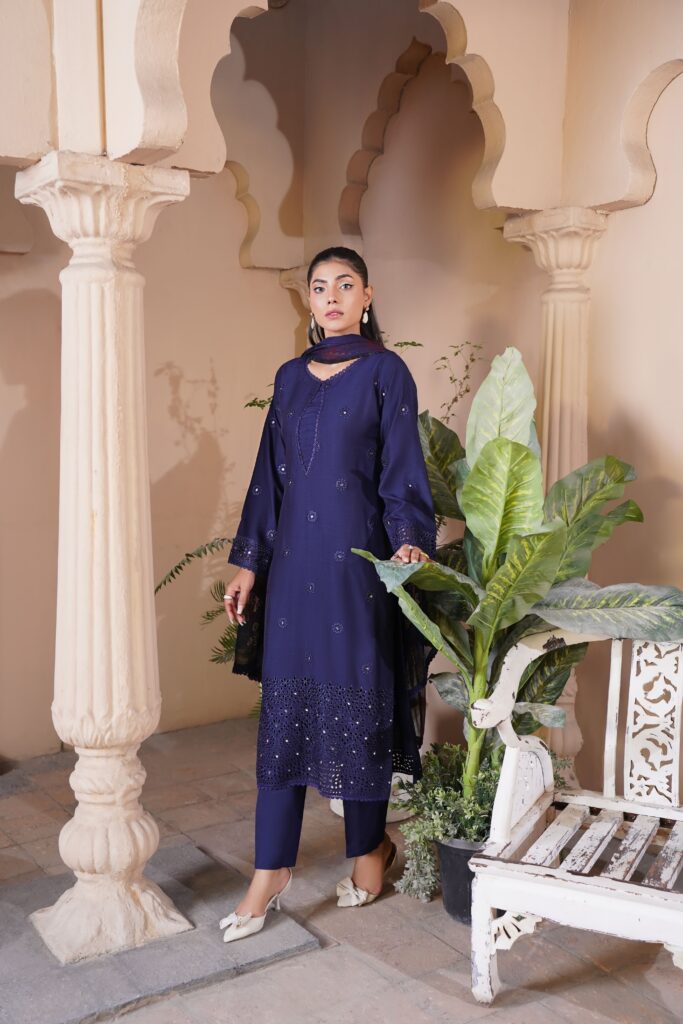 Model in traditional Pakistani attire in Lahore setting with classic architecture.