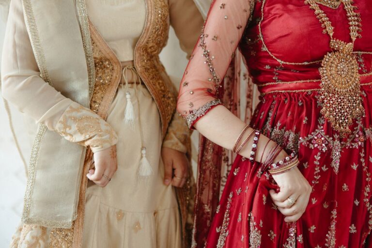 Close-up of women in traditional attire showcasing ornate embroidery and jewelry.